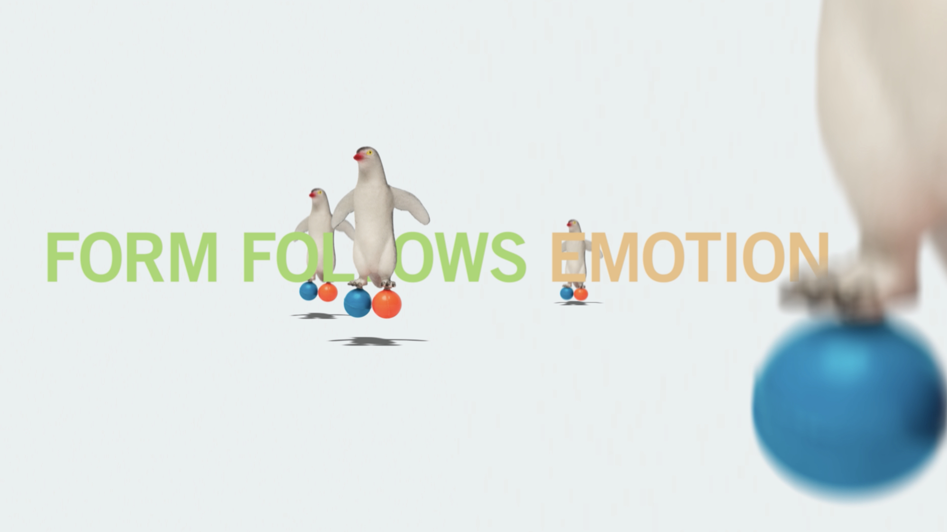 Pinguine auf farbigen Bällen vor Schriftzug „Form Follows Emotion“. Motiv der Orange Council-Kampagne für die Messe Orgatec.